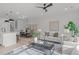 Open concept living room with seating area and large windows, adjacent to kitchen at 600 Rocky Knob Ct, Raleigh, NC 27601