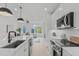 Modern kitchen with white cabinets, island, and stainless steel appliances at 614 Rocky Knob Ct, Raleigh, NC 27601