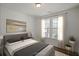 Bright bedroom with neutral decor, large windows, and hardwood floors at 8820 Melvin St # 16, Willow Springs, NC 27592