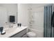 Clean bathroom with white tub, shower, and gray vanity at 8820 Melvin St # 16, Willow Springs, NC 27592