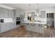 Modern kitchen with gray cabinets, center island, and stainless steel appliances at 8820 Melvin St # 16, Willow Springs, NC 27592