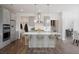 Modern kitchen with gray cabinets, center island, and stainless steel appliances at 8820 Melvin St # 16, Willow Springs, NC 27592