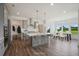 Open concept kitchen with gray cabinets, large island, and hardwood floors at 8820 Melvin St # 16, Willow Springs, NC 27592