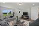 Bright living room featuring a comfy sectional sofa and large windows offering a tranquil view at 8820 Melvin St # 16, Willow Springs, NC 27592