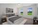 Serene bedroom with a king-size bed and large windows overlooking the fields at 8820 Melvin St # 16, Willow Springs, NC 27592