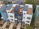 Modern townhouses featuring rooftop decks with outdoor furniture, an aerial perspective at 600 Rocky Knob Ct, Raleigh, NC 27601