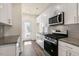 Modern kitchen with stainless steel appliances and granite countertops at 795 Washington St, Fuquay Varina, NC 27526