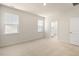 Spacious bedroom with carpet, two windows, and en-suite bathroom access at 795 Washington St, Fuquay Varina, NC 27526