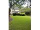 Large backyard with lush green grass and mature trees at 2638 Davis St, Raleigh, NC 27608