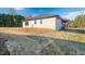 White brick home with a side yard and landscaping at Lot 4 Harding St, Efland, NC 27243