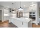 Modern kitchen with white cabinets, quartz countertops, and stainless steel appliances at Lot 4 Harding St, Efland, NC 27243