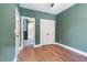 Charming bedroom with green walls, hardwood floors and access to a bathroom at Lot 4 Harding St, Efland, NC 27243