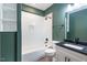 Simple bathroom with a bathtub, toilet, and vanity with dark countertop at Lot 4 Harding St, Efland, NC 27243