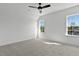 Bright bedroom with carpet, ceiling fan, and large windows at 55 Harvest View Way, Franklinton, NC 27525