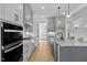 Spacious kitchen featuring gray cabinets, granite countertops, and a large island at 55 Harvest View Way, Franklinton, NC 27525