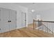 Upstairs hallway with hardwood floors and access to bedrooms at 55 Harvest View Way, Franklinton, NC 27525