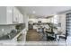 Open kitchen with breakfast bar and view into dining area at 2403 Ivy Knoll Dr, Mebane, NC 27302