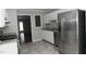 Kitchen boasts granite countertops, stainless steel appliances, and white cabinets at 4622 Jacquline Ln, Raleigh, NC 27616