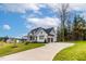 Two-story home with gray siding, stone accents, and a two-car garage at 60 Harvest View Way, Franklinton, NC 27525