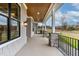 Covered front porch with stone pillars and metal railing offers relaxing outdoor space at 60 Harvest View Way, Franklinton, NC 27525