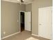 Bright bedroom featuring neutral walls, ceiling fan and two closets at 196 Collin Dr, Roxboro, NC 27574