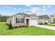 New construction home with gray siding, brick accents, and two-car garage at 2408 Trevana Way, Graham, NC 27253