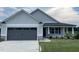 Two-car garage and front yard of a craftsman style home at 46 Scotties Ridge Dr, Princeton, NC 27569