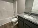 Bathroom with granite vanity, tub, and vinyl flooring at 46 Scotties Ridge Dr, Princeton, NC 27569