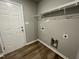 Bright laundry room features built-in shelving and vinyl flooring at 46 Scotties Ridge Dr, Princeton, NC 27569