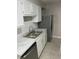 Kitchen with white cabinets, stainless steel appliances, and marble countertops at 1330 Park Glen Dr # 104, Raleigh, NC 27610