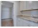 Well-appointed laundry room with cabinets and a utility sink at 2756 Lacy Holt Rd, Graham, NC 27253