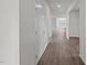 Bright hallway with wood-look flooring and doors at 1673 Abberly Pl, Graham, NC 27253