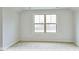 Bright bedroom with carpeted floors and a large window at 1677 Abberly Pl, Graham, NC 27253