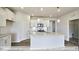 Modern kitchen with white cabinets and granite island at 1677 Abberly Pl, Graham, NC 27253