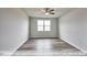 Spacious bedroom with wood flooring and a large window at 1677 Abberly Pl, Graham, NC 27253