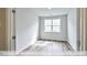 Well-lit bedroom with wood-look floors and a window offering natural light at 1677 Abberly Pl, Graham, NC 27253