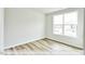 Bright bedroom with wood-look flooring and a large window at 1677 Abberly Pl, Graham, NC 27253