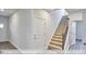 Elegant staircase with carpeted steps and metal railing at 1677 Abberly Pl, Graham, NC 27253