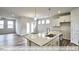Modern kitchen with island, granite counters, and stainless steel appliances at 1677 Abberly Pl, Graham, NC 27253