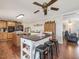 Open kitchen with large island, wood cabinets, and breakfast bar at 557 Olives Chapel Rd, Apex, NC 27502