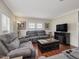 Spacious living room featuring gray sofas and a fireplace at 557 Olives Chapel Rd, Apex, NC 27502