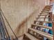 Unfinished basement with wooden stairs and fishing poles at 557 Olives Chapel Rd, Apex, NC 27502