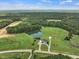 Aerial view of home, pond, and surrounding land at 557 Olives Chapel Rd, Apex, NC 27502