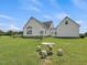 Home's side yard with patio and seating area at 557 Olives Chapel Rd, Apex, NC 27502