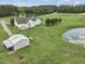 Aerial view of house, detached garage, and pond at 557 Olives Chapel Rd, Apex, NC 27502