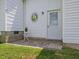 Small patio area with sun decoration and white siding at 557 Olives Chapel Rd, Apex, NC 27502