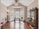 Sunlit living room with bay windows and hardwood floors at 557 Olives Chapel Rd, Apex, NC 27502