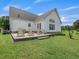 Brick patio with wooden chairs and fire pit at 557 Olives Chapel Rd, Apex, NC 27502