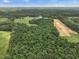 Aerial view of property highlighting wooded acreage at 557 Olives Chapel Rd, Apex, NC 27502