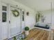 Front porch with wooden swing and decorative wreath at 557 Olives Chapel Rd, Apex, NC 27502